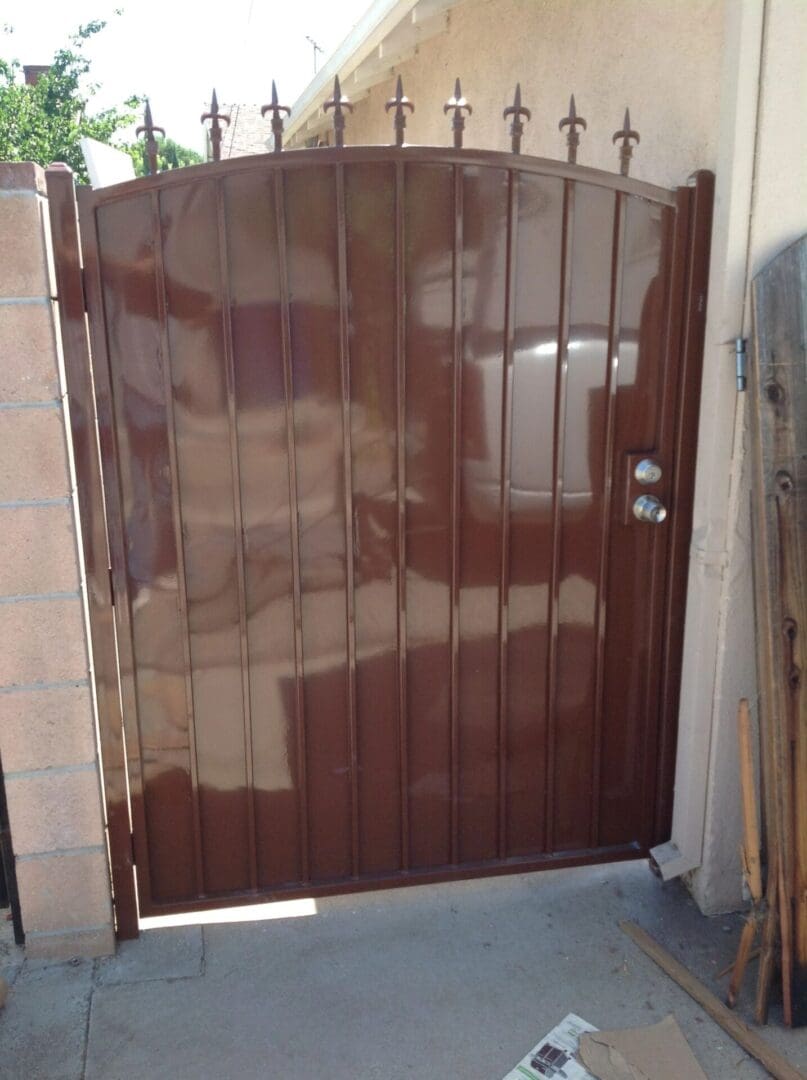 Brown metal gate with decorative spikes.