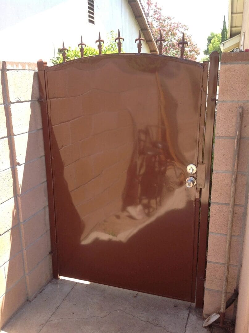 Shiny brown metal gate with reflection.