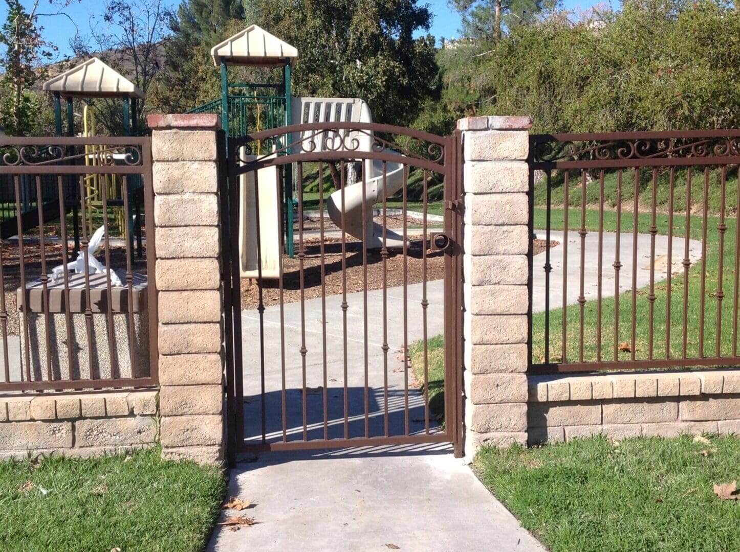 Playground gate with slide and pathway.