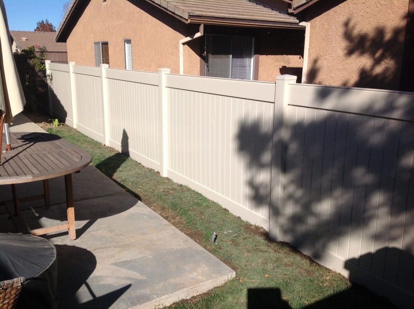 Backyard with wooden fence and patio furniture.