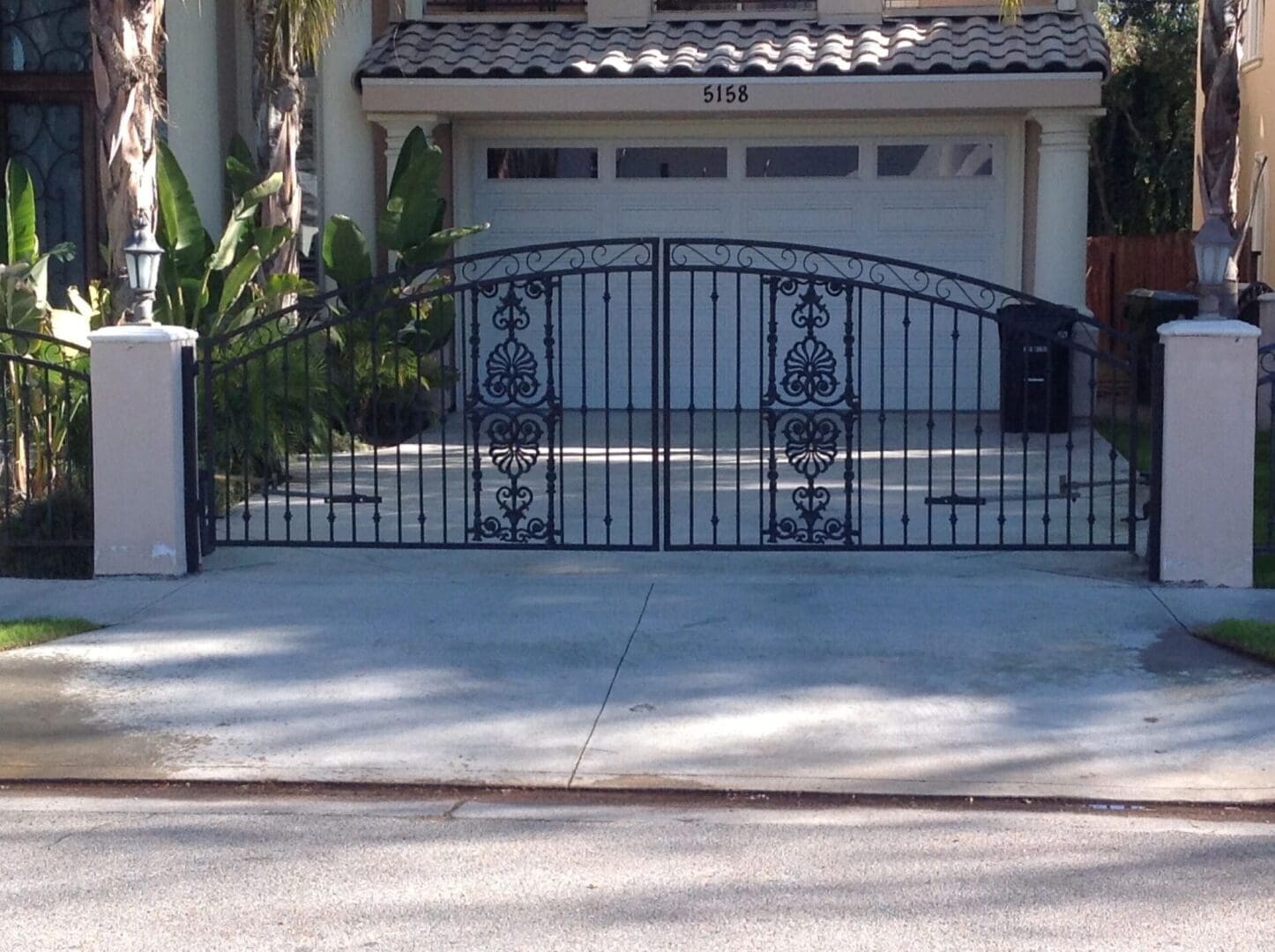 Decorative wrought iron driveway gate and garage.