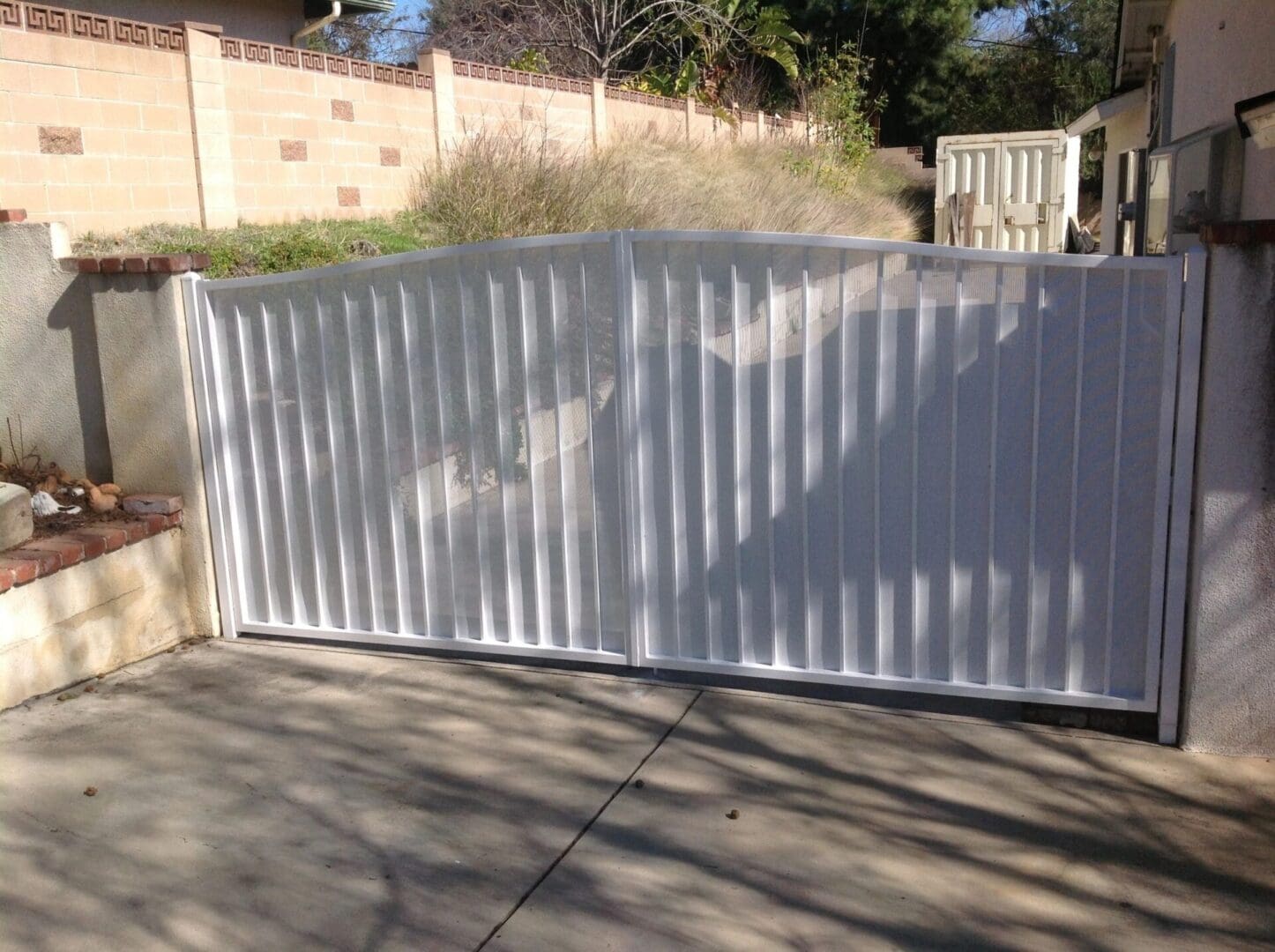White metal gate across a driveway.