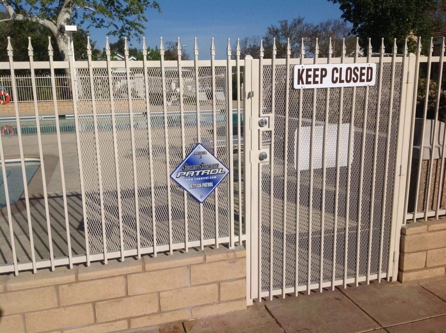 Pool gate with "Keep Closed" sign.