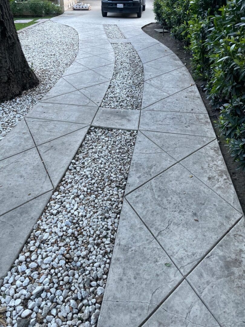 Concrete driveway with decorative stone inlay.