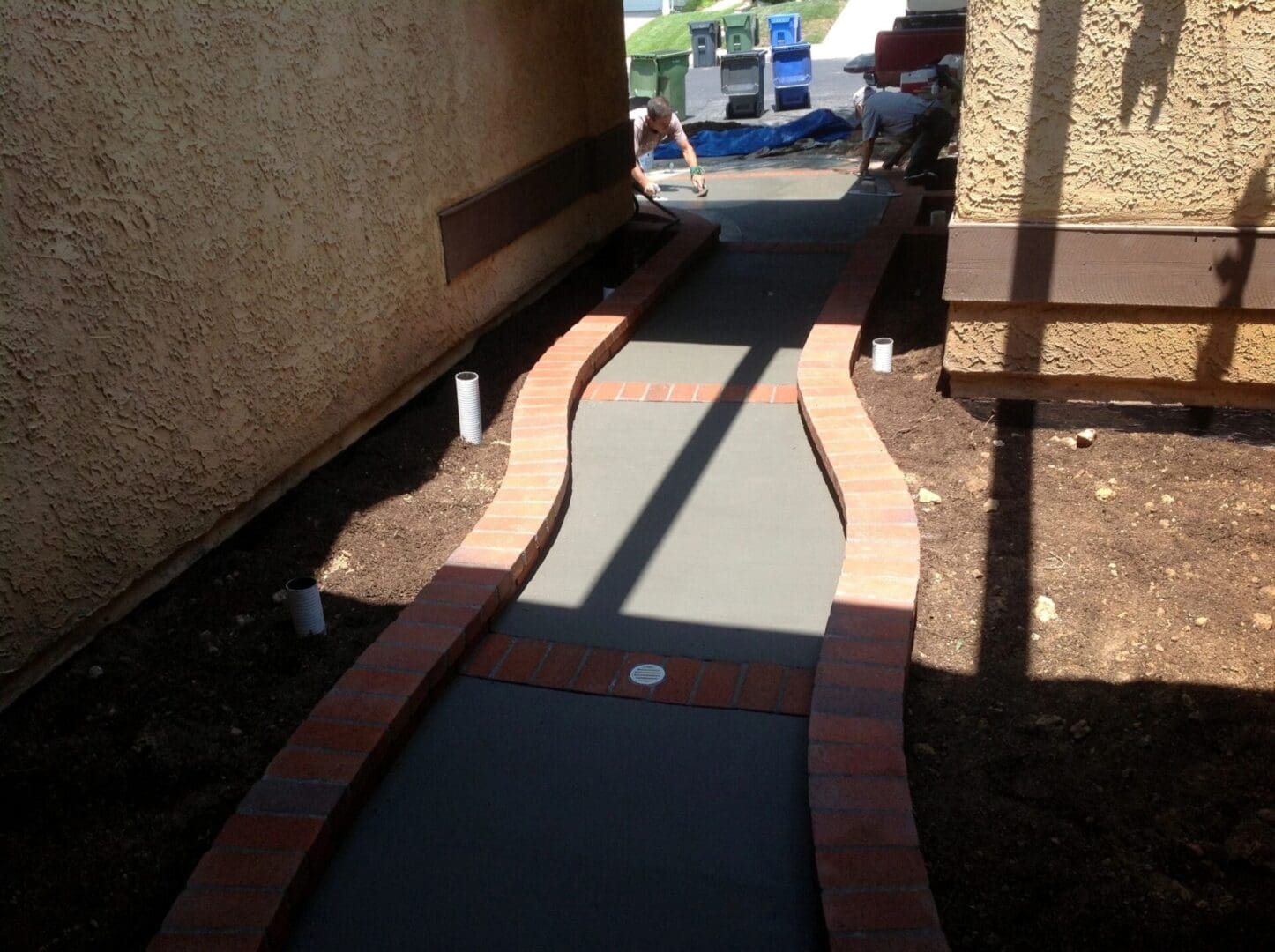 Curved concrete pathway between two buildings.