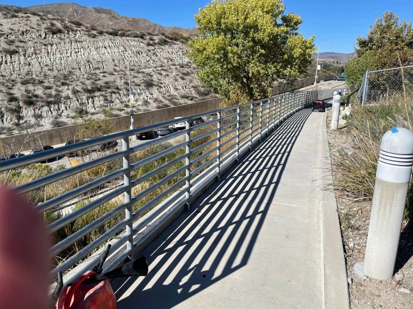 Pathway with railing and mountain view.