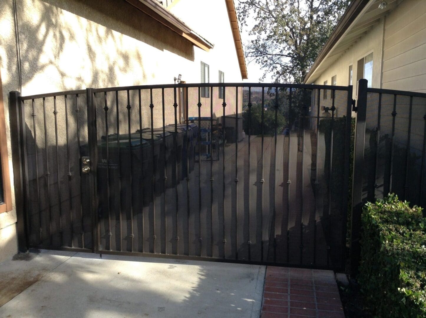 Black metal gate between two houses.