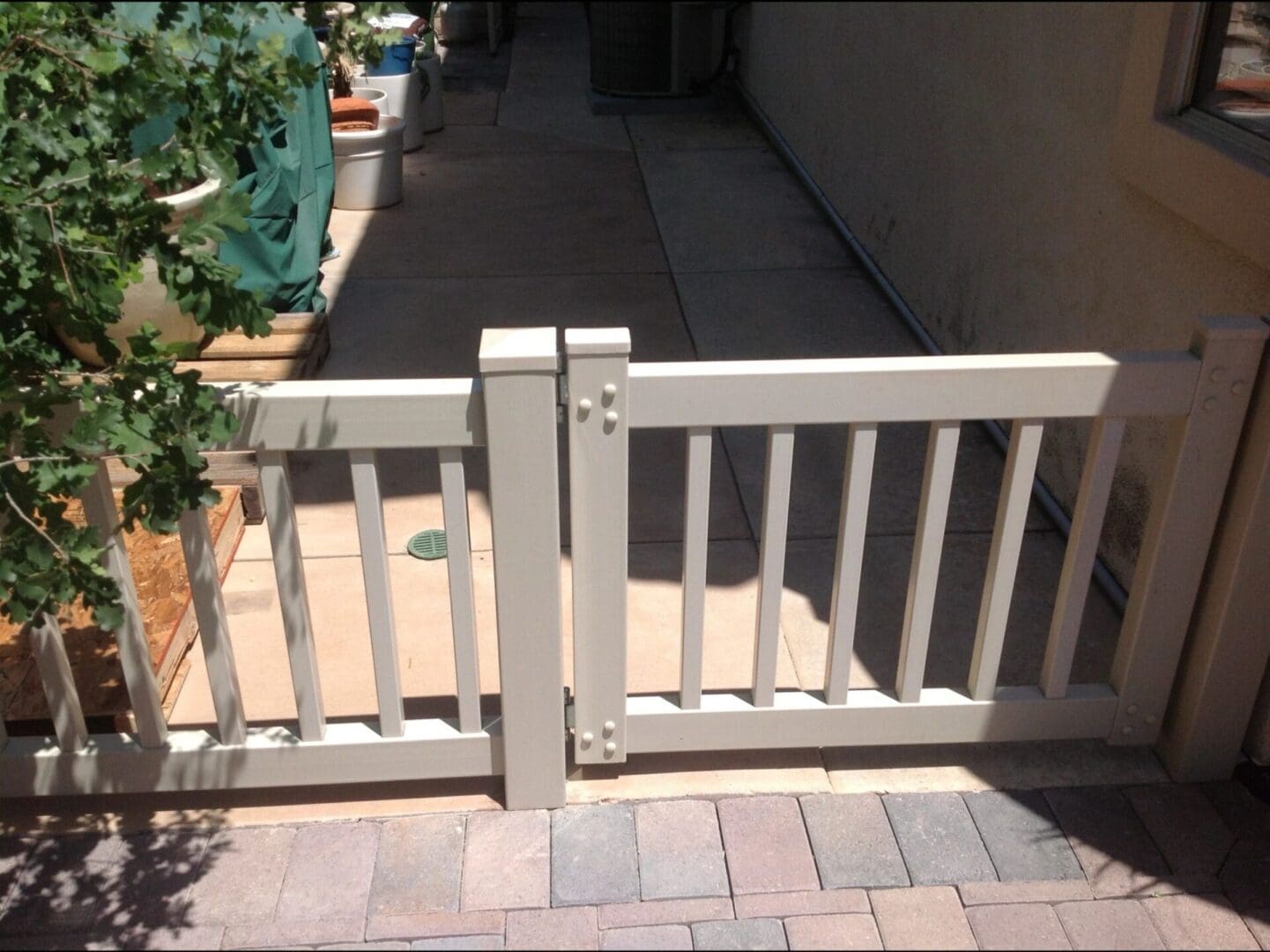 White wooden gate on a sunny patio.