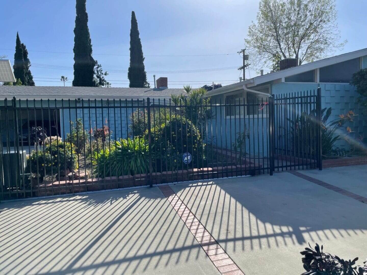 Gated garden area with trees and plants.