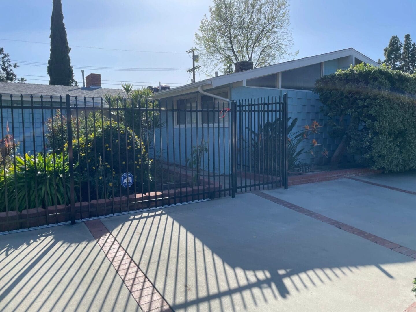 Gated house with garden and driveway.