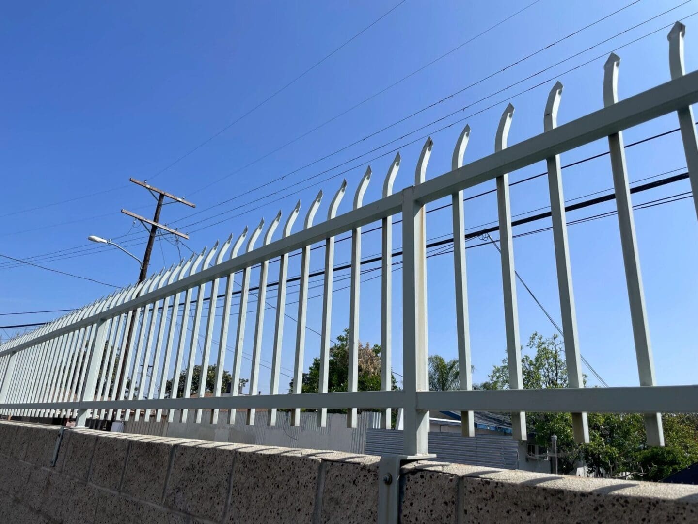 Metal fence with blue sky background.
