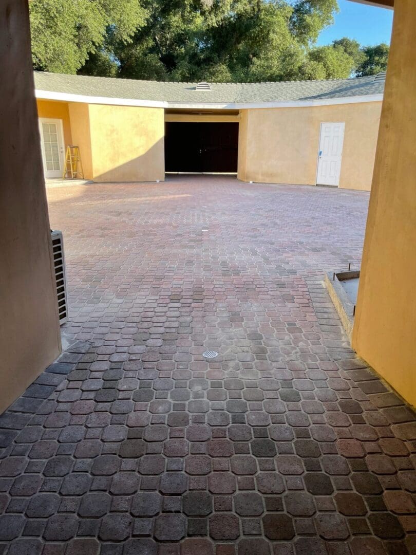 Courtyard with cobblestone paving and yellow walls.
