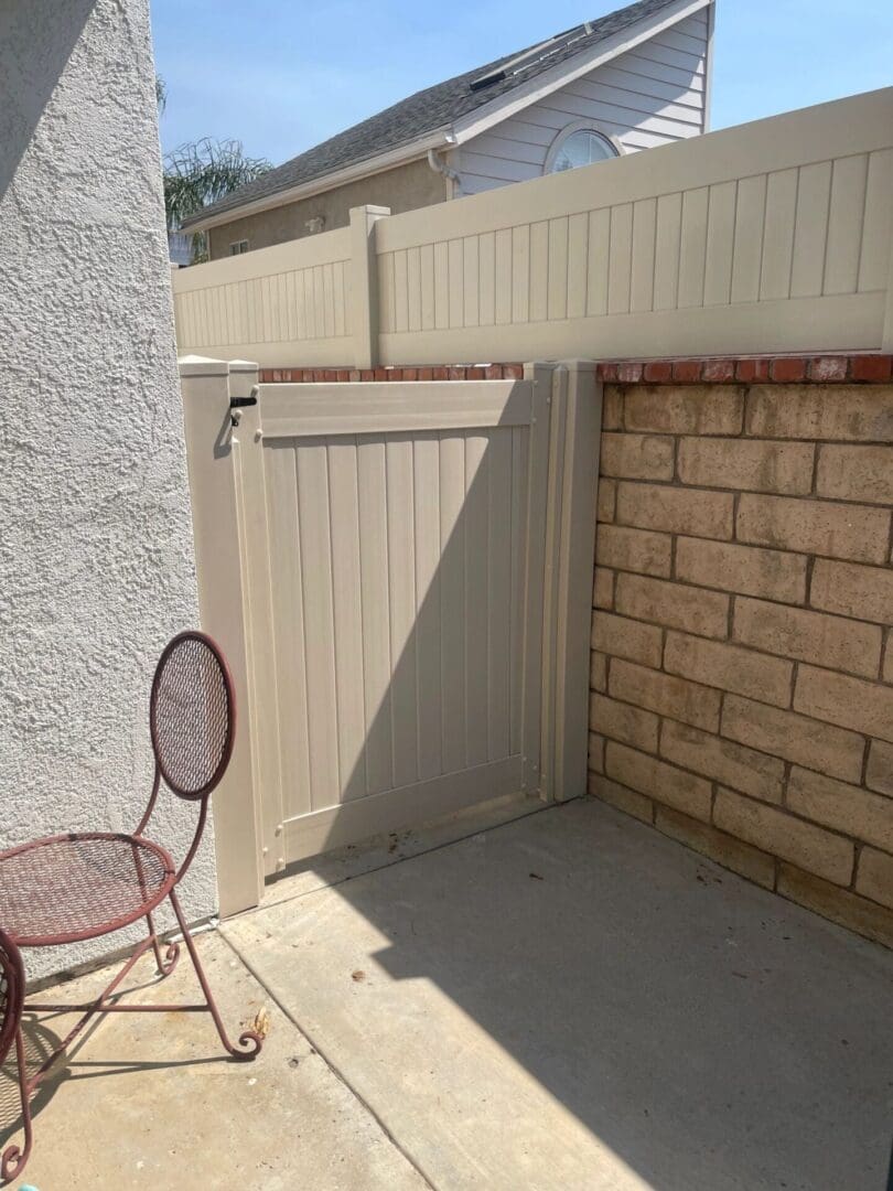Outdoor patio with gate and brick wall.