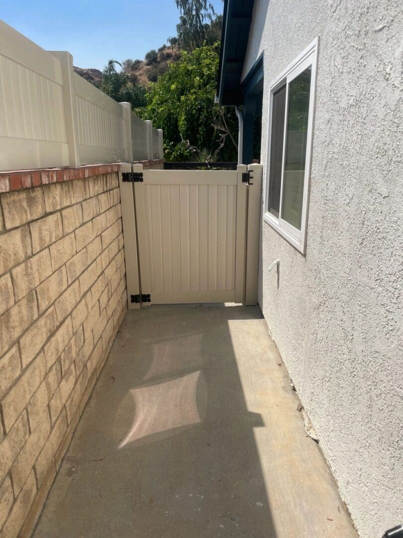 Narrow pathway with gate and window.