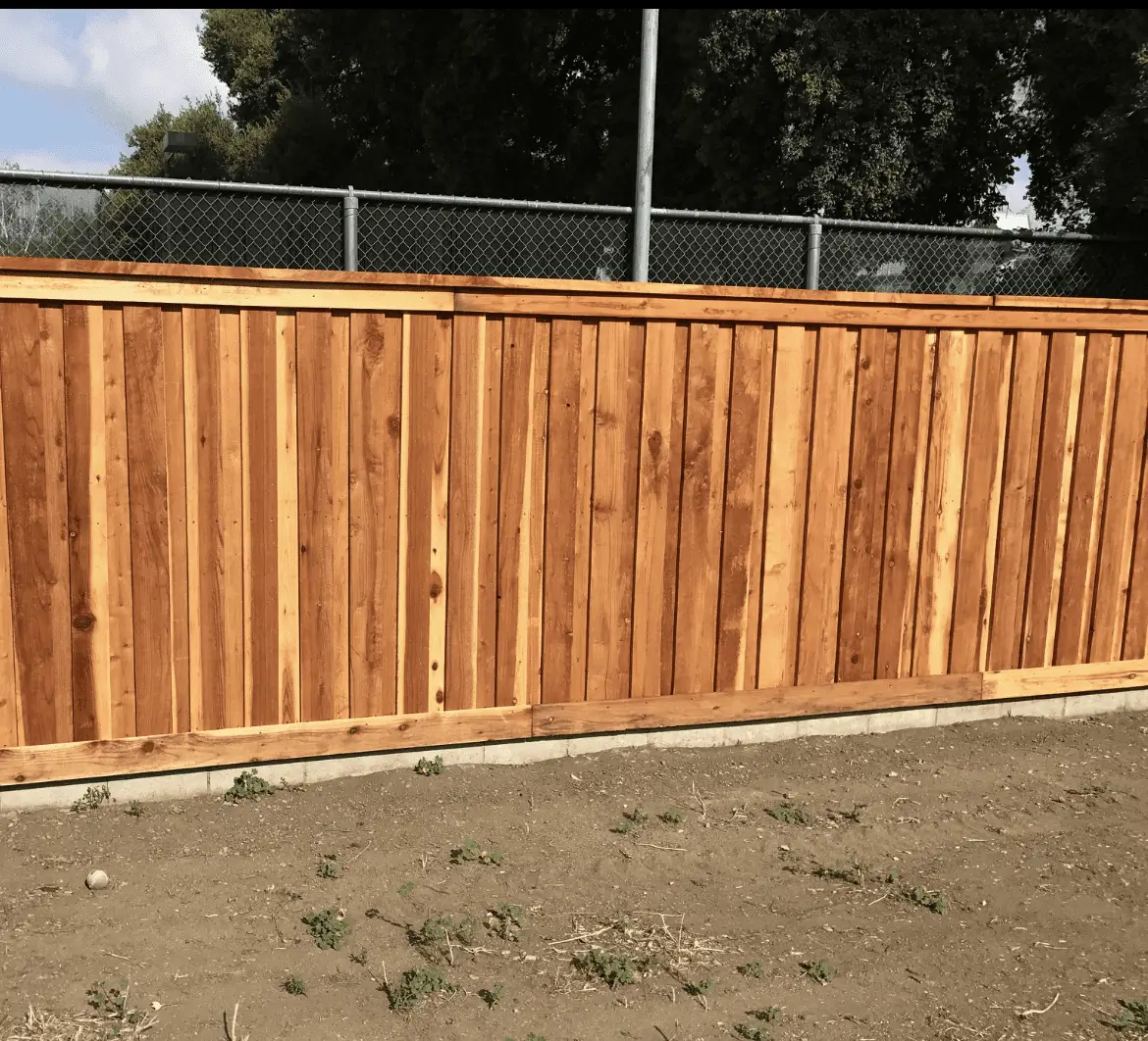 A wooden fence panel with a natural finish in an outdoor setting.